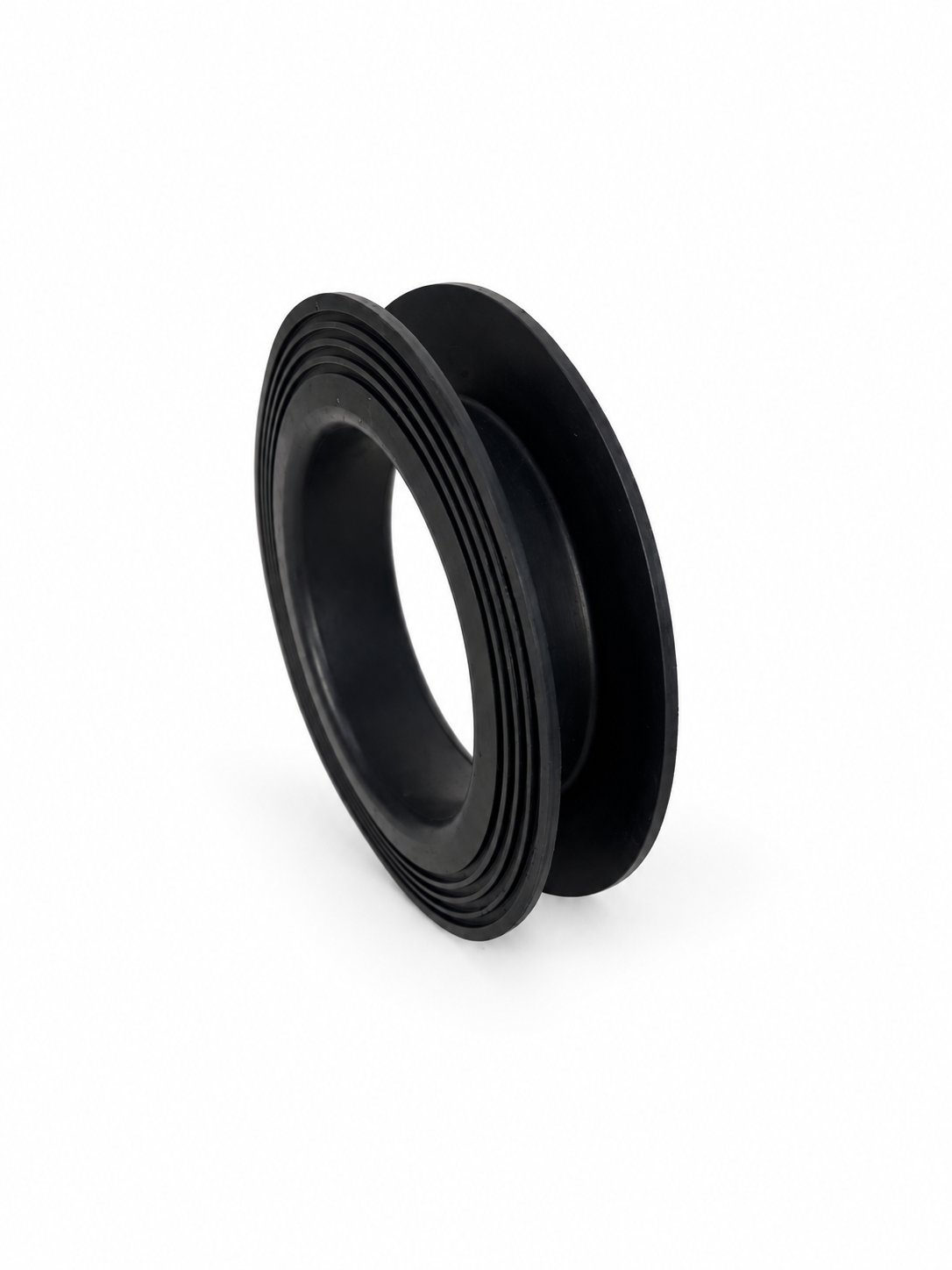 Black rubber circular component with flanges and concentric surface grooves